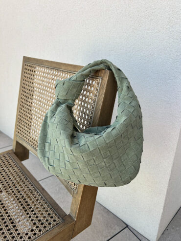 Introducing our chic and stylish summer woven knot bag in a gorgeous shade of suede green! This unique bag is perfect for adding a pop of color to your summertime wardrobe. Handcrafted with a woven design and featuring a trendy knot detail, this bag is sure to turn heads wherever you go. The soft suede material gives it a luxurious feel, while the spacious interior provides plenty of room for all your essentials. Elevate your summer style with this must-have accessory!